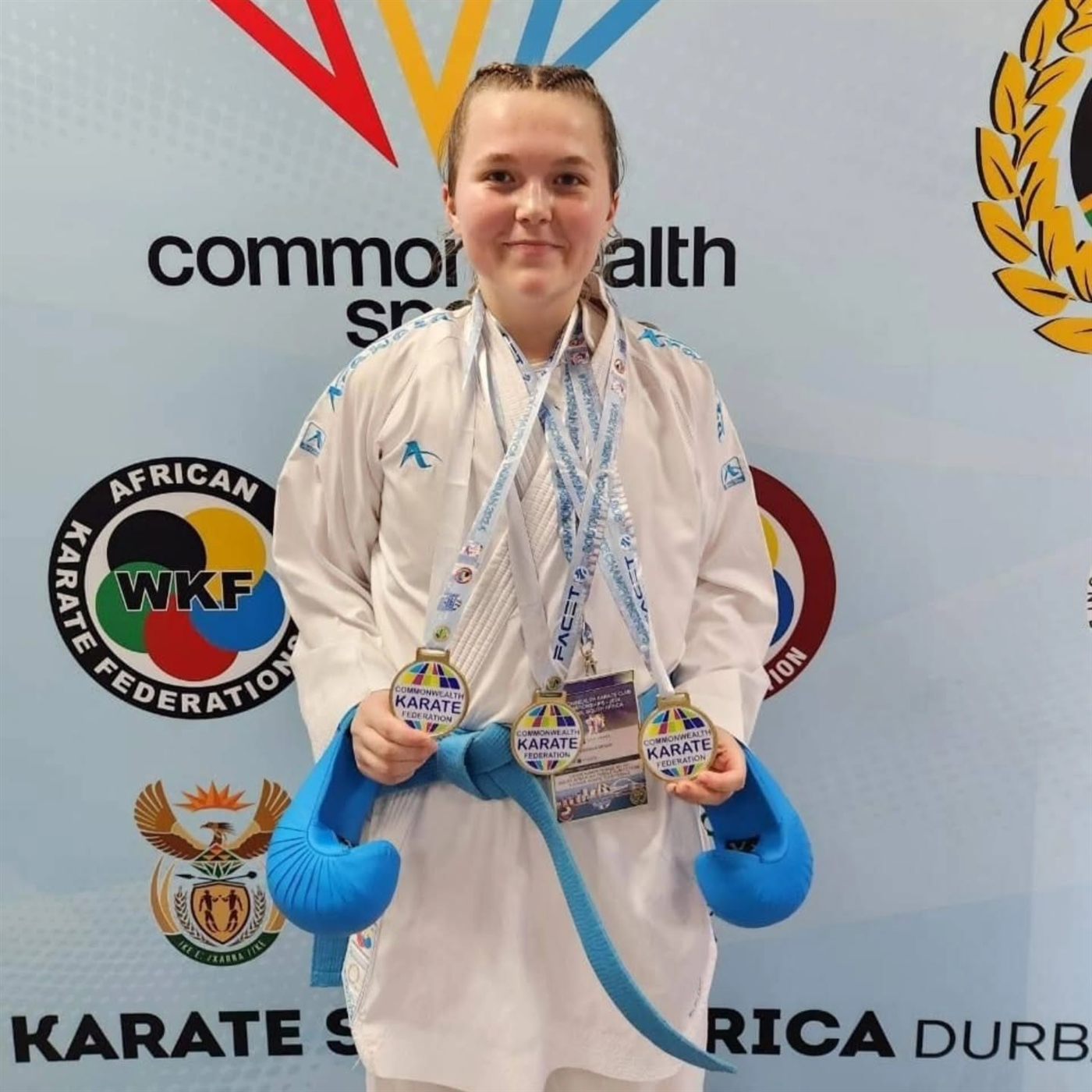 KarateZone athlete holding three medals